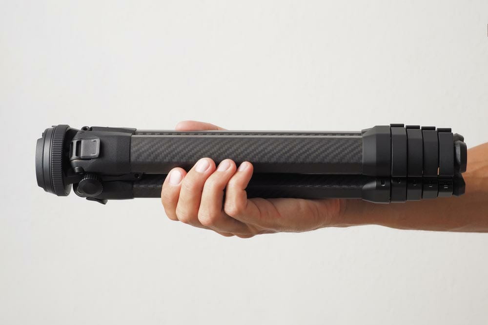 Hand Holding Carbon fiber Tripod for Photographer. Travel Photo Tripod.